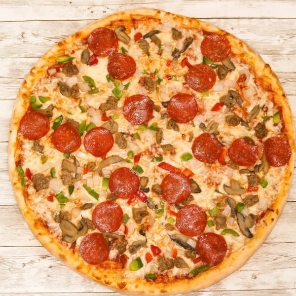 A Villa Pizza supreme pizza with pepperoni, sausage, mushrooms, onions, and peppers on a wooden table.